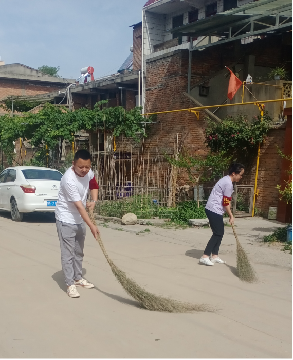 党员志愿服务者清理道路卫生。